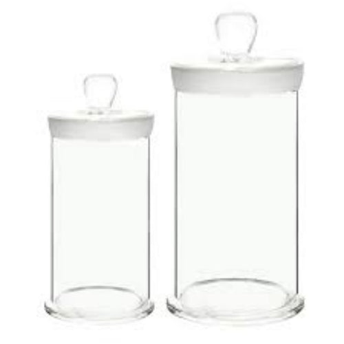 Two clear glass jars with white lids on a white background